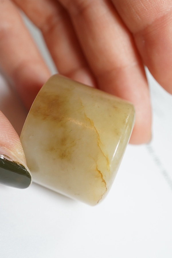 A Chinese pale celadon jade archer's thumb ring, 18th/19th century